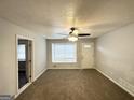 Cozy living room featuring carpeted floors and natural light at 29 Hickory Ct, Dallas, GA 30157