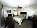 A bedroom featuring a ceiling fan, a window, and furnishings at 7619 Ward Ln, Jonesboro, GA 30236