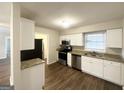 Stylish kitchen featuring white cabinets, stainless steel appliances, and granite countertops at 3647 Brookcrest Cir, Decatur, GA 30032