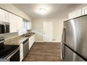 Bright kitchen featuring stainless steel appliances, granite countertops, and updated cabinets at 3647 Brookcrest Cir, Decatur, GA 30032