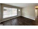 Living room featuring fresh paint, wood flooring, and a window providing ample natural light at 1986 Bandera Dr, Decatur, GA 30032