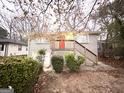 Charming brick home featuring a front porch with a red door and well-maintained landscaping at 320 Brooks Sw Ave, Atlanta, GA 30310