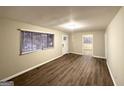 Inviting living room featuring wood flooring, neutral walls, and natural light from a large window at 320 Brooks Sw Ave, Atlanta, GA 30310