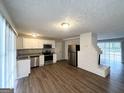 Open kitchen features stainless steel appliances, granite countertops, and hardwood floors at 3415 Homera Pl, Decatur, GA 30032