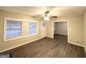 Bright living room with hardwood floors, large windows, and a ceiling fan at 648 Ozburn Nw Rd, Atlanta, GA 30318