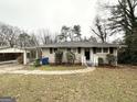 Inviting ranch-style home featuring a covered carport and mature landscaping in the front yard at 4250 Utoy Sw Ct, Atlanta, GA 30331