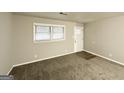Neutral living room with carpet and natural light streaming through a window, next to the front door at 4250 Utoy Sw Ct, Atlanta, GA 30331