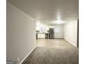 Bright open-concept living space flowing into a modern kitchen with stainless steel appliances at 4250 Utoy Sw Ct, Atlanta, GA 30331