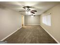 Spacious living room features neutral paint, plush carpeting, and modern ceiling fans at 1761 Carter Cir, East Point, GA 30344