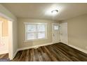 Bright living area features wood-look floors, neutral walls, large windows, and ample lighting at 2193 Polar Rock Sw Ave, Atlanta, GA 30315