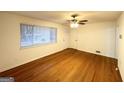 Bright living room featuring natural light, gleaming hardwood floors, and a ceiling fan at 2537 Bonnybrook Sw Dr, Atlanta, GA 30311