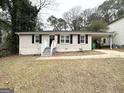 Single-story home featuring a welcoming entrance, dark shutters, and a convenient carport at 2544 Brentwood Rd, Decatur, GA 30032