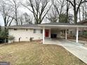 Single-story home with a covered carport and red front door at 2740 Bonnybrooke, Atlanta, GA 30311