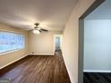 Bright living room featuring modern flooring, a ceiling fan, and a large window with natural light at 2740 Bonnybrooke, Atlanta, GA 30311