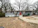 View of a charming one-story home with a red front door, complemented by a front yard at 2819 Gresham Rd, Atlanta, GA 30316