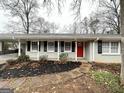 Inviting brick home exterior with a bright red front door and walkway at 3976 Bright Star Rd, Douglasville, GA 30135