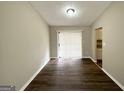 A dining room with wood-look flooring, a sliding glass door, and views of a neutral-colored wall at 4305 Old Lake Dr, Decatur, GA 30034