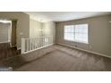 A carpeted living room with a large window that allows for natural light and features neutral-colored walls at 4305 Old Lake Dr, Decatur, GA 30034