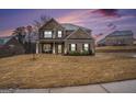 Inviting brick home with a covered porch, perfect for enjoying evenings outdoors at 121 Amelia Way, Ellenwood, GA 30294