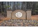 Clark Estates West brick community entrance sign surrounded by a wooded area at 121 Amelia Way, Ellenwood, GA 30294