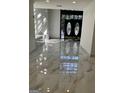 Bright entryway with marble floors reflecting natural light from the black double doors at 2119 Pine Heights Ne Dr, Atlanta, GA 30324