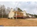 View of the home showing the covered front porch, side yard, and architectural details at 417 River Trace Dr, Villa Rica, GA 30180