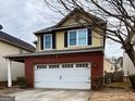 Exterior view of a two-story home with brick and siding, featuring a two-car garage at 2517 Oakleaf Rdg, Lithonia, GA 30058