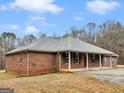 Attractive brick home featuring a classic design and a welcoming red front door at 445 Turner Dr, Mcdonough, GA 30252