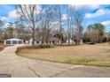 Spacious property with a long driveway, detached garage and lots of mature trees at 225 Highway 212 S, Covington, GA 30014