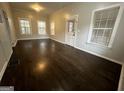 Bright and airy living room featuring freshly painted walls and polished dark wood floors at 1573 Carroll Nw Dr, Atlanta, GA 30318