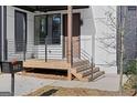 Modern home featuring a charming front porch and minimalist railings at 567 Middle Sw St, Atlanta, GA 30310