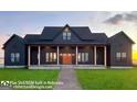 Inviting two-story modern farmhouse with charming front porch and large manicured lawn at 0 Lot 2 Mcbride Rd, Fayetteville, GA 30215