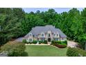 Expansive well-manicured property, mature trees provide privacy, and circular drive lead to the home at 709 Prestige Pt, Peachtree City, GA 30269