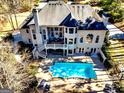 Aerial view of backyard with large pool, deck, and ample seating areas at 709 Prestige Pt, Peachtree City, GA 30269