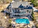 Aerial view of a backyard featuring a patio deck, stairs, and in-ground pool at 709 Prestige Pt, Peachtree City, GA 30269