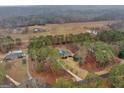 Aerial view of the property showing the home, pool, and surrounding land and neighboring houses at 185 Lady Helen Ct, Fayetteville, GA 30214