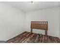 Empty bedroom showing wood-look flooring and a headboard in an otherwise unfurnished space at 3623 Meadow Glen Cir, Ellenwood, GA 30294