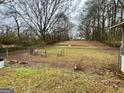 Large fenced-in backyard features mature trees and plenty of room to relax at 733 Linda Way, Forest Park, GA 30297