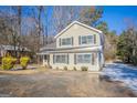 Traditional two-story home with gray siding, a well-kept yard and black window shutters at 3049 Flat Shoals Rd, Atlanta, GA 30349