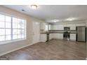 Bright kitchen features white cabinets, stainless steel appliances, and wood-look flooring at 3049 Flat Shoals Rd, Atlanta, GA 30349