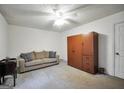 Bright living room with neutral carpeting, ceiling fan, and ample space for relaxation at 2854 Botany Dr, Jonesboro, GA 30236