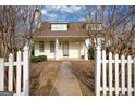 Charming two-story home with a welcoming front porch and manicured landscaping at 2683 Mariner Way, Villa Rica, GA 30180
