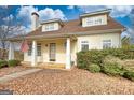 Inviting two-story home with front porch, decorative columns, and meticulously maintained landscaping at 2683 Mariner Way, Villa Rica, GA 30180