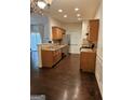 Well-lit kitchen featuring wooden cabinets, stainless steel appliances, and dark wood floors at 2764 Keystone Ave, Lithonia, GA 30058