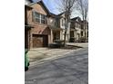 Townhouses lining the street, each with attached garages, covered entrances, and minimal landscaping at 2764 Keystone Ave, Lithonia, GA 30058