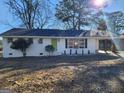 Updated one story brick home features a green door and a covered parking area at 480 Pine Pl, Riverdale, GA 30274