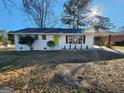 Well-maintained one story brick home with a bright green door and covered side parking at 480 Pine Pl, Riverdale, GA 30274