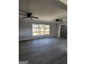 Spacious living room featuring modern gray walls, updated flooring and plenty of natural light at 480 Pine Pl, Riverdale, GA 30274