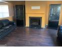 Cozy living room featuring a fireplace flanked by black display cabinets and hardwood floors at 5620 Sable Way, Atlanta, GA 30349