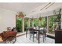 Bright dining area with large windows, a dark wood dining set, and decorative plants at 613 Rock Springs Pass, Dallas, GA 30157